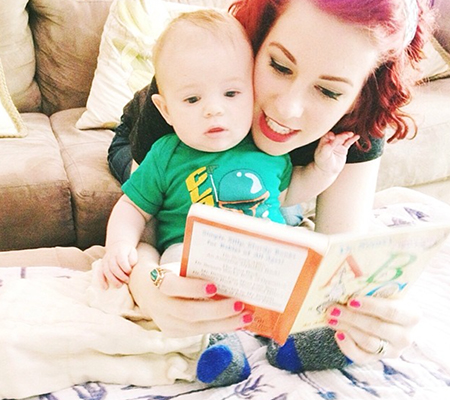 An adult and baby playing speech games at home