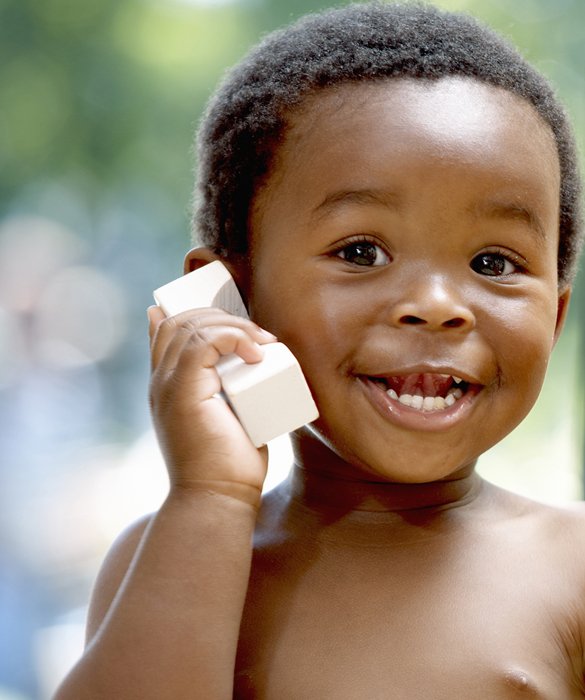 a toddler on the phone smiling