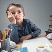 a bored child showing symptoms of an expressive language disorder