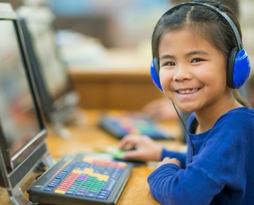 girl with a speech disorder on a computer