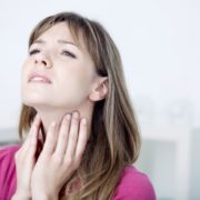 woman massaging her vocal nodules