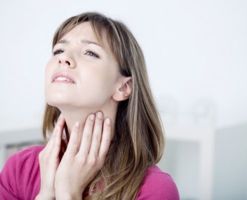 woman massaging her vocal nodules
