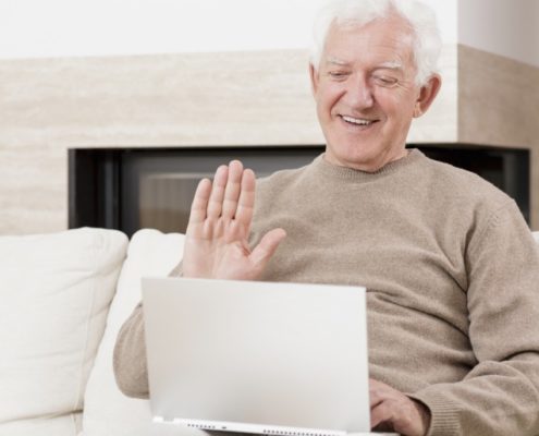 a man with Alzheimer's doing online speech therapy
