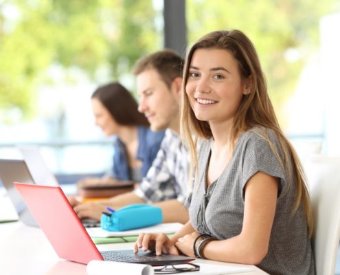 a woman on a laptop doing Reading Comprehension for Adults