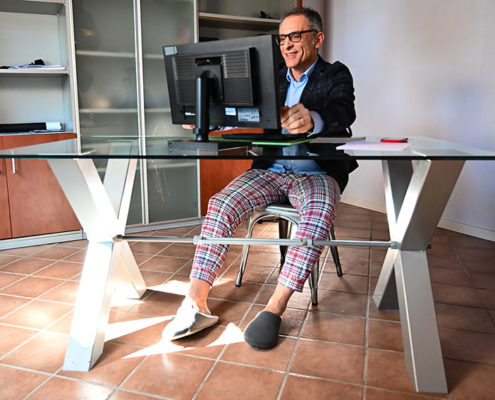 a man at home on his computer doing online speech therapy