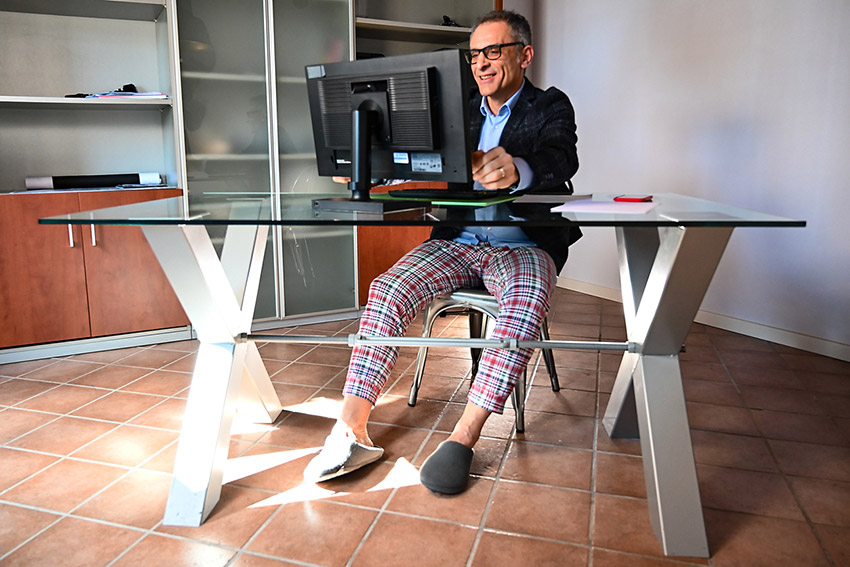 a man at home on his computer doing online speech therapy