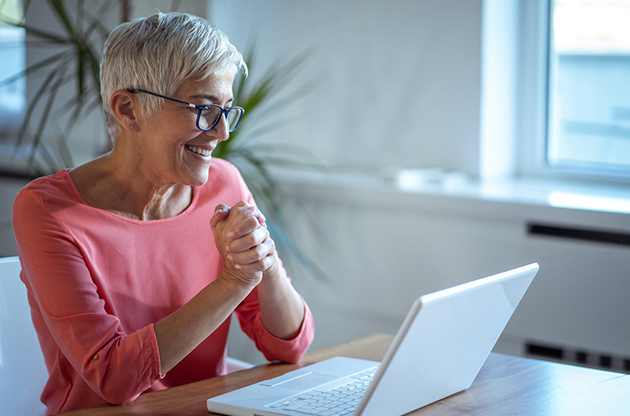 women looking to laptop representing online speech therapy