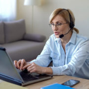 a woman using online speech therapy at home for brain injury recovery