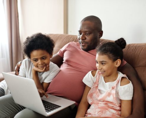 a family on a home computer with questions about speech therapy