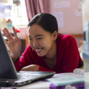 a woman with signs of traumatic brain injury on her laptop