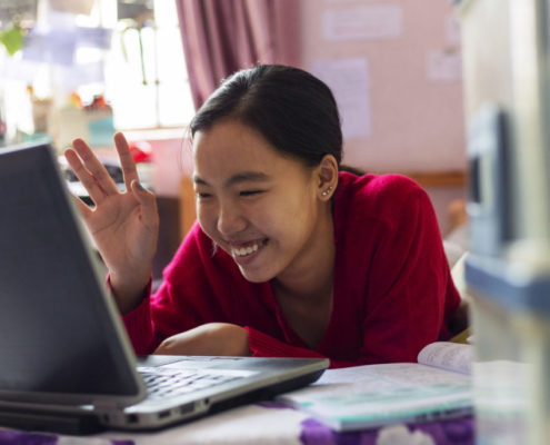 a woman with signs of traumatic brain injury on her laptop