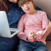 a child at home working on her communication skills through online learning