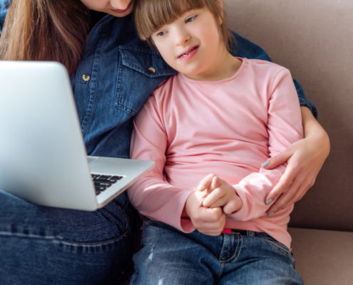 a child at home working on her communication skills through online learning