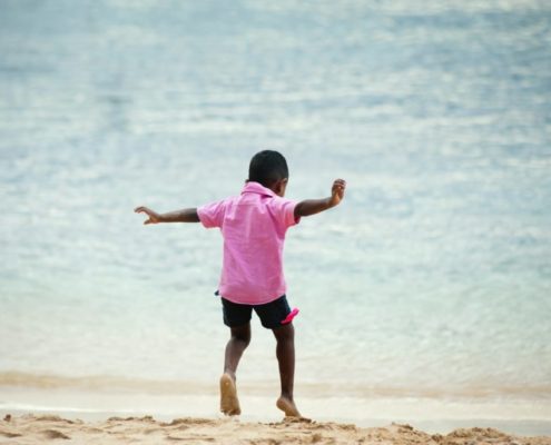 a child at the beach doing speech therapy during the holidays