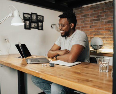 a man at home with ADHD doing online speech therapy