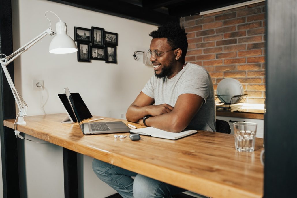 a man at home with ADHD doing online speech therapy