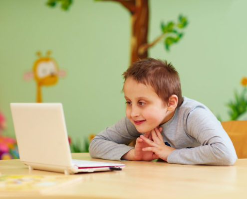 a boy with Asperger's syndrome at home doing online speech therapy