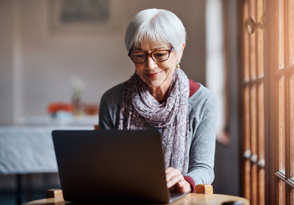 a woman on a laptop with Parkinson's Disase