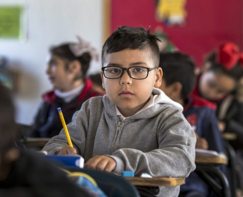 a child with a speech disorder at his desk at school