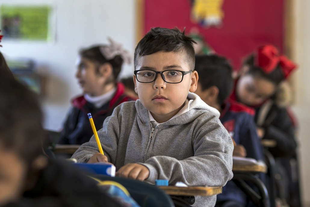 a child with a speech disorder at his desk at school