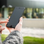 a woman researching speech therapy on her smartphone