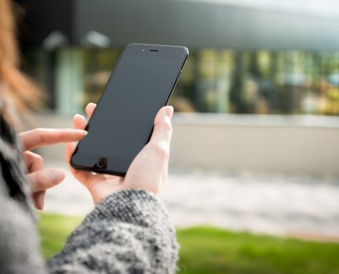 a woman researching speech therapy on her smartphone