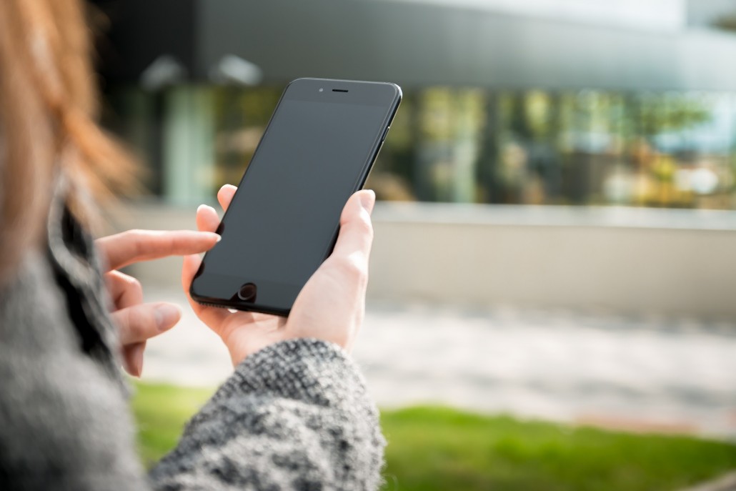 a woman researching speech therapy on her smartphone