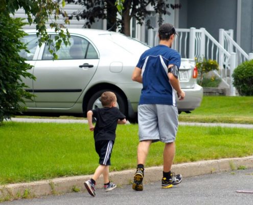 father and son communicating while jogging