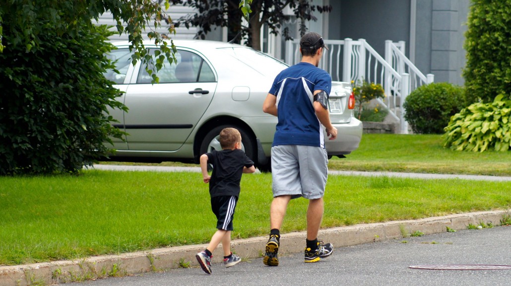 father and son communicating while jogging