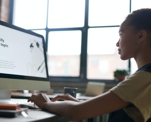 young girl on a laptop at home researching