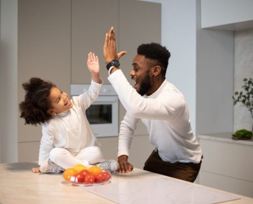 father with his 3 year old daughter practicing speech
