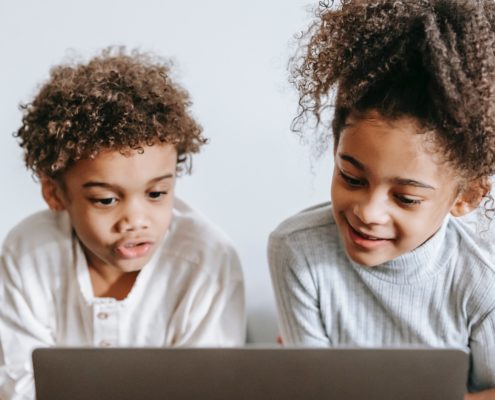 two children doing online speech therapy