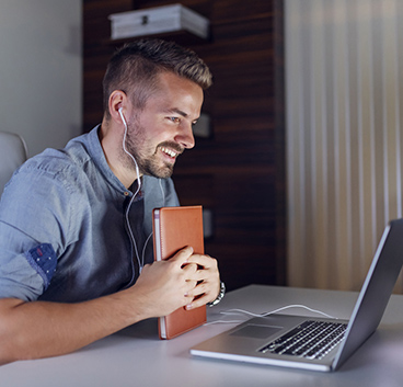 business men smiling while looking to notebook