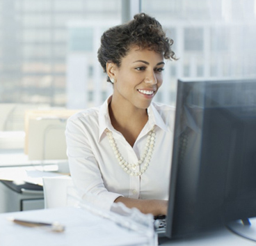 business woman smiling while looking to notebook