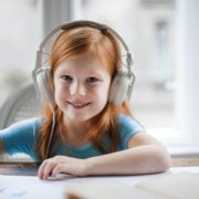 A child at home doing PROMPT therapy on her laptop