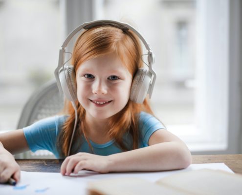 A child at home doing PROMPT therapy on her laptop