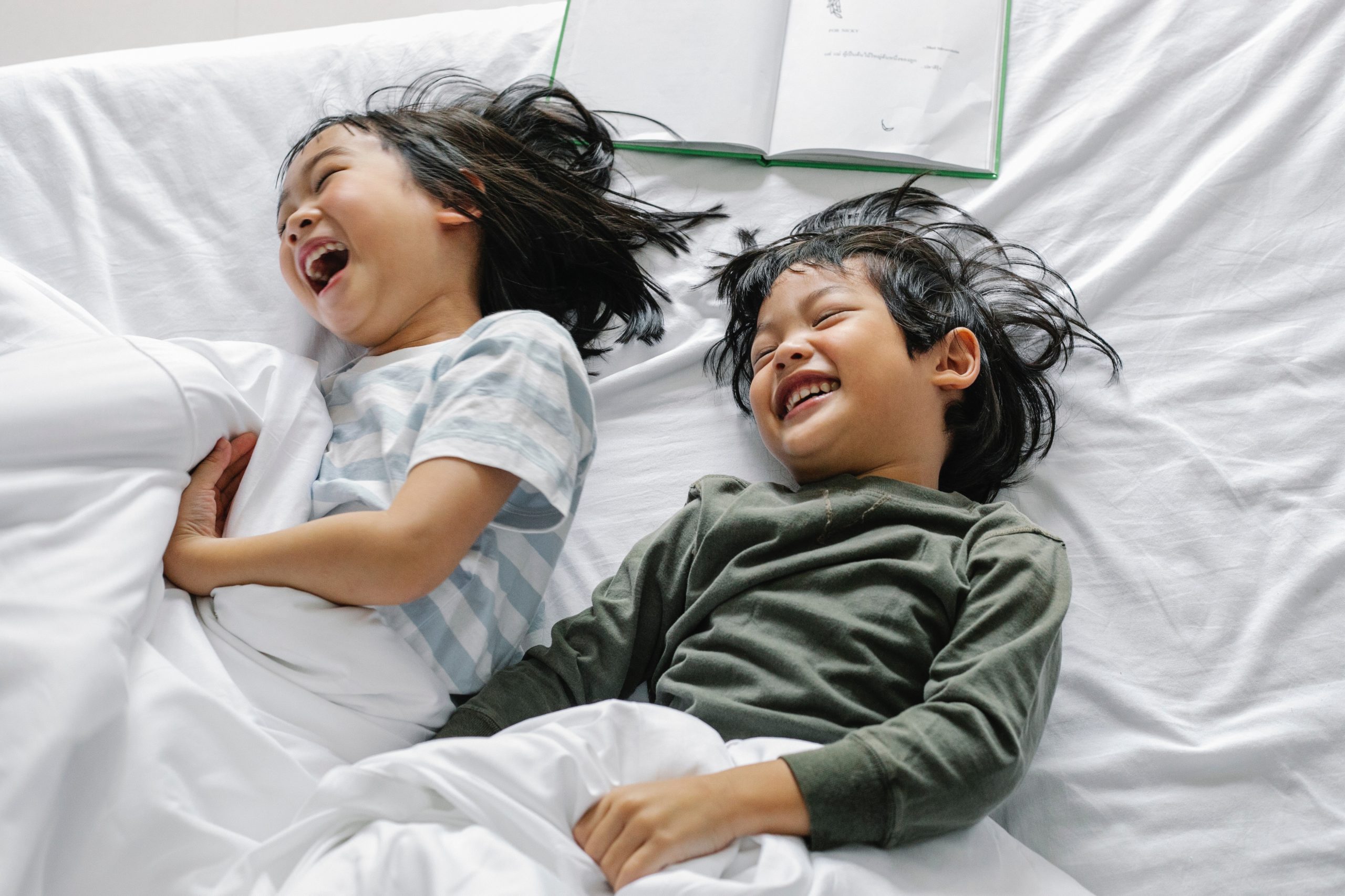 A boy and girl at home laughing and speaking to each other