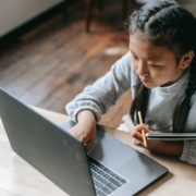 a girl practicing her reading at home on her computer