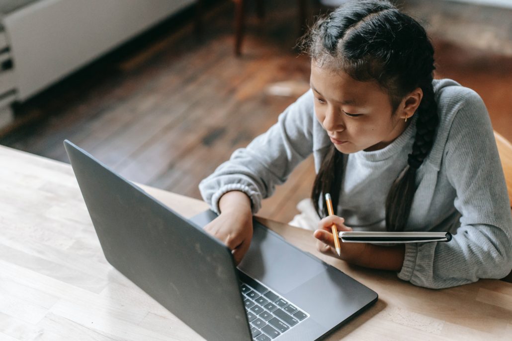 a girl practicing her reading at home on her computer