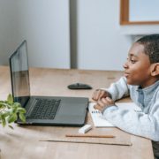 a 5 year old child at a laptop learning at home