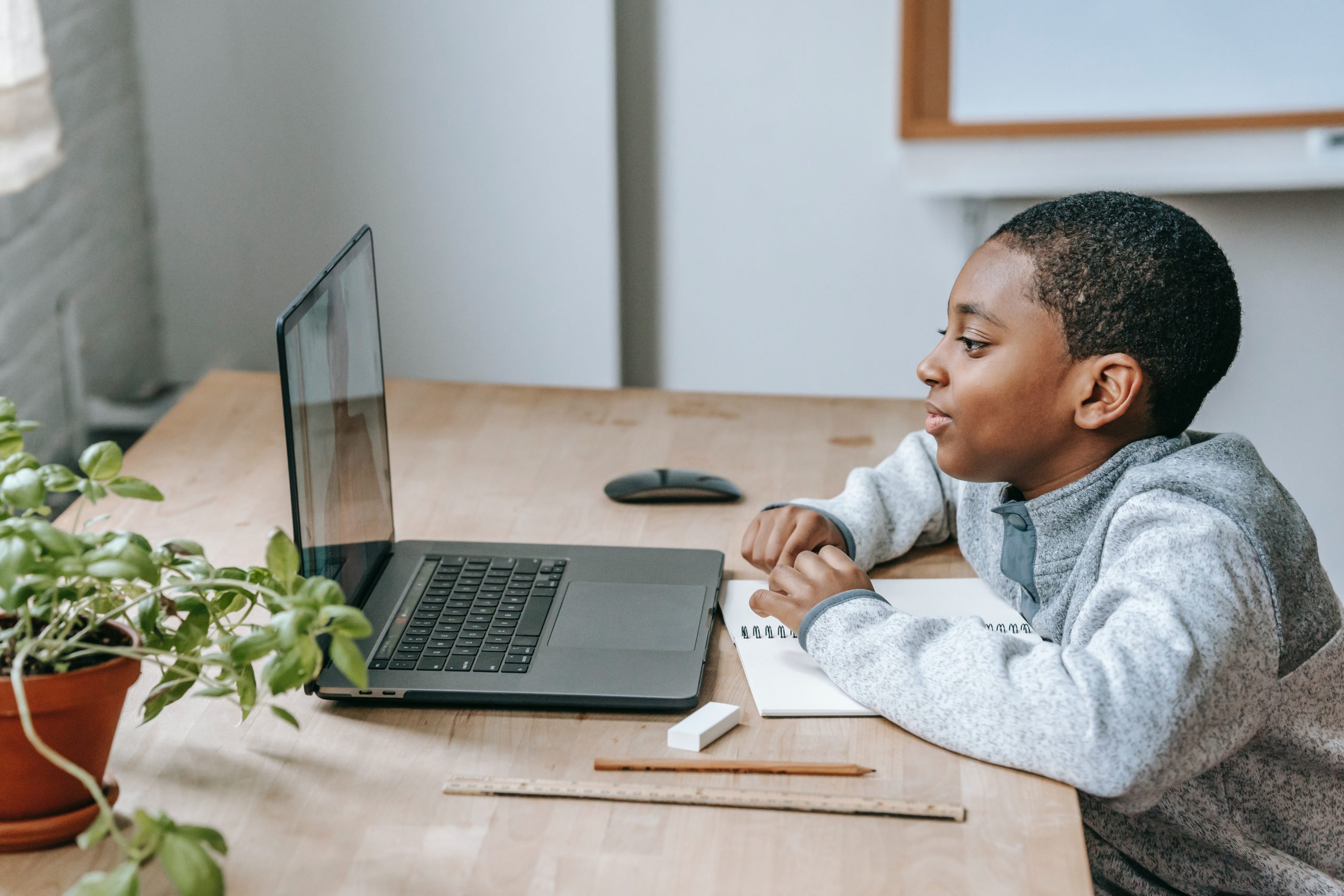 a 5 year old child at a laptop learning at home