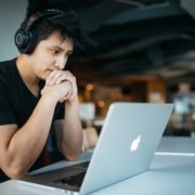 an adult on his laptop doing online speech therapy