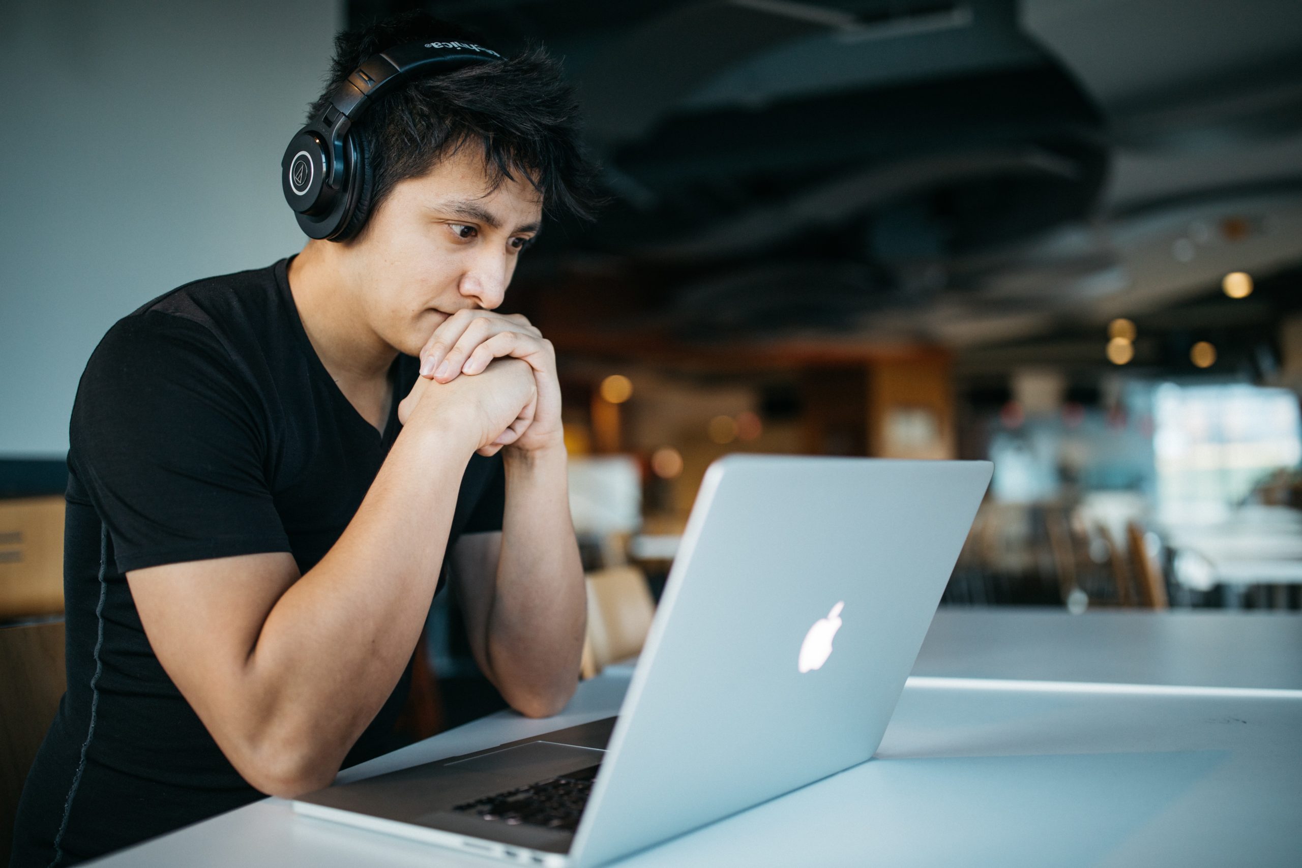 an adult on his laptop doing online speech therapy