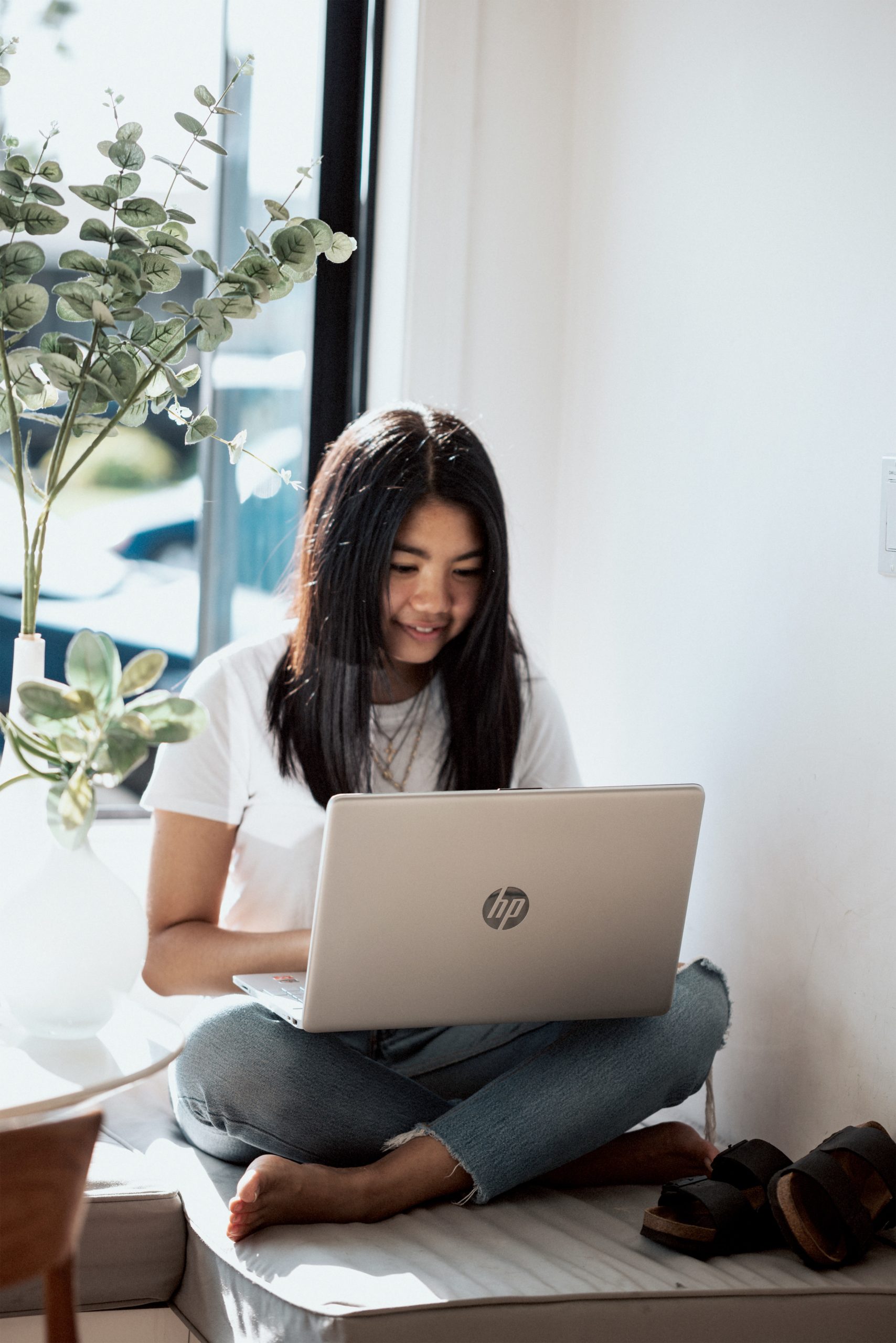 A girl at home with a speech disorder taking online speech therapy classes from her laptop