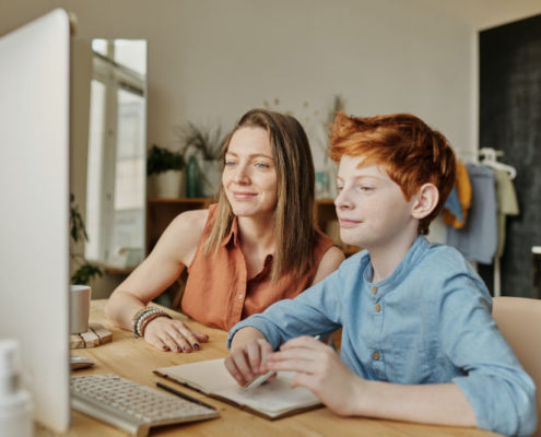 A child at home working on his stutter with an online speech therapist