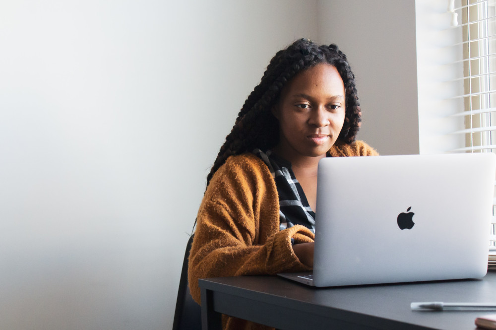 a bilingual person at home on a laptop