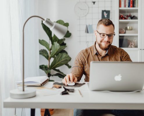 man at home on a laptop learning about speech therapy