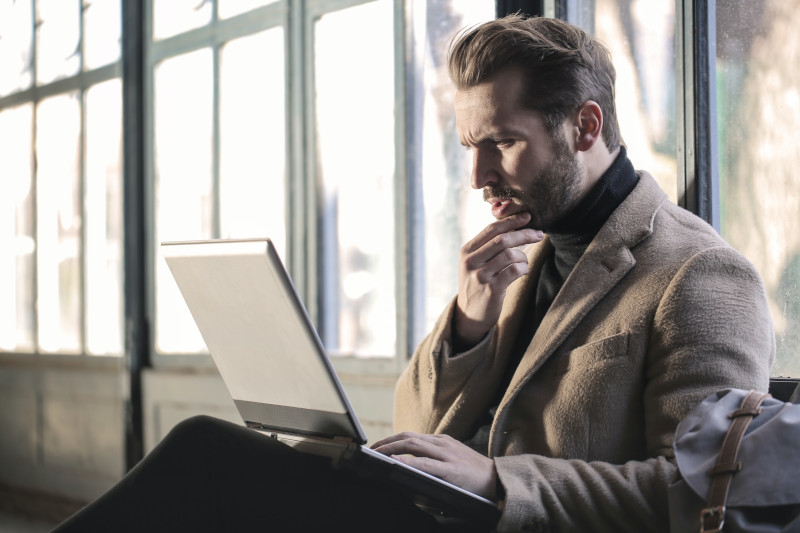 a man on his laptop that suffers pressured speech