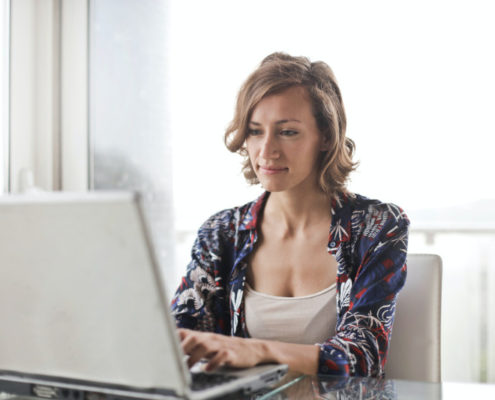 woman with a tremor at home on her computer