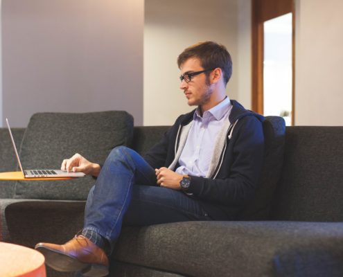 a man at home on his couch working on his communication skills